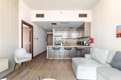 a living room with a couch and a kitchen at ZenStay - Haven of tranquility and luxury in Dubai