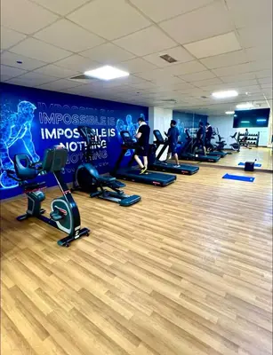 a group of people exercising in a gym at Vibrant studio - 15m to marina in Dubai