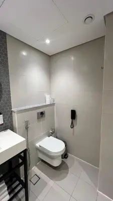 a bathroom with a toilet and a sink at Private Apartment in Novotel JVT Comfort for 4 Guests in Dubai