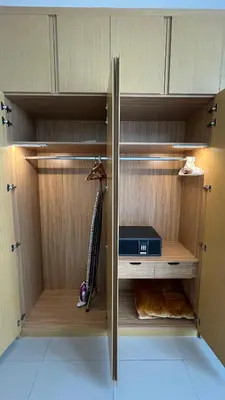 a closet with a wooden cabinet with a desk at Private Apartment in Novotel JVT Comfort for 4 Guests in Dubai