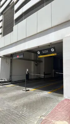 a parking garage with a parking meter in front of a building at Private Apartment in Novotel JVT Comfort for 4 Guests in Dubai