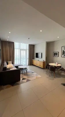 a living room with a couch and a table at Private Apartment in Novotel JVT Comfort for 4 Guests in Dubai