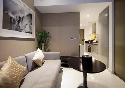 a living room with a couch and a table at Stylish Studio in Damac Prive Canal-View Studio in Dubai