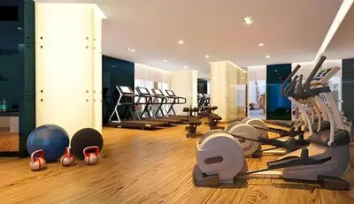 a gym with many exercise equipment in a room at Stylish Studio in Damac Prive Canal-View Studio in Dubai
