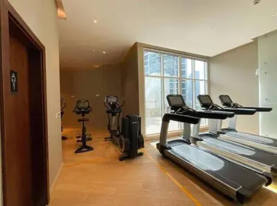 a gym with treadmills and ellipticals in a room at Stylish Studio in Damac Prive Canal-View Studio in Dubai