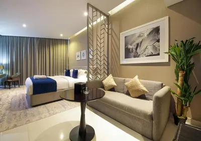 a hotel room with a couch and a bed at Stylish Studio in Damac Prive Canal-View Studio in Dubai