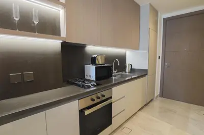 a kitchen with a sink and a microwave on a counter at Stunning Studio in Peninsula Five in Dubai