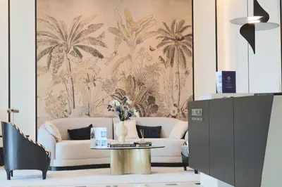 a living room with a couch and a table at Casa Royale Vacation Home - JVC in Dubai