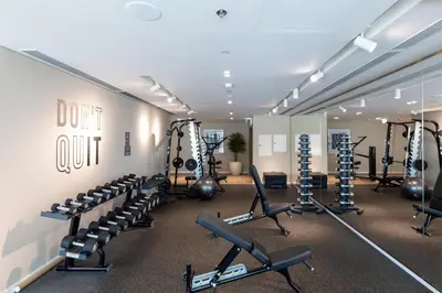 a gym with rows of treadmills and weights at Maison Privee - Waterfront Living with Unparalleled Sea & Palm Vws in Dubai
