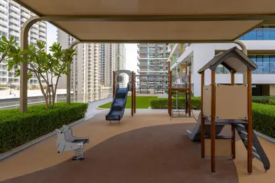 a playground with a slide and a swing at Maison Privee - Waterfront Living with Unparalleled Sea & Palm Vws in Dubai