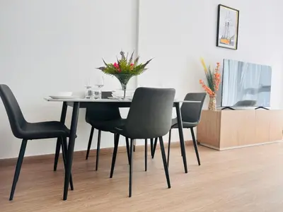 a dining room table with chairs and a vase of flowers on it at Airvistas Elevate Living 1BHK in Dubai
