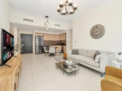 a living room with a couch and a tv at Stylish 3BR in BurjCrown Balcony & HighEnd Comfort in Dubai