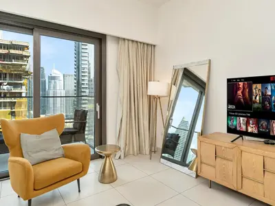 a living room with a television and a large window at Stylish 3BR in BurjCrown Balcony & HighEnd Comfort in Dubai