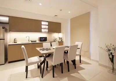 a kitchen and dining room with a table and chairs at Upscale2BR in Burj Crown Pool,Gym & Stunning Views in Dubai