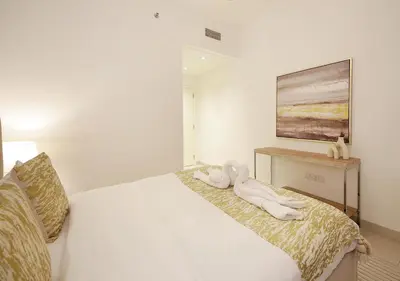 a bedroom with a bed with two towels on it at Upscale2BR in Burj Crown Pool,Gym & Stunning Views in Dubai