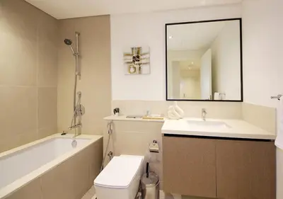 a bathroom with a sink and a toilet and a bath tub at Upscale2BR in Burj Crown Pool,Gym & Stunning Views in Dubai