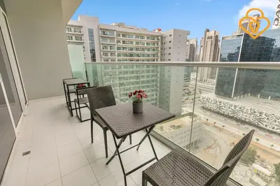 a balcony with a table and chairs and a view of a city at Keysplease 1 BR Apt, Vera Residence Business Bay in Dubai