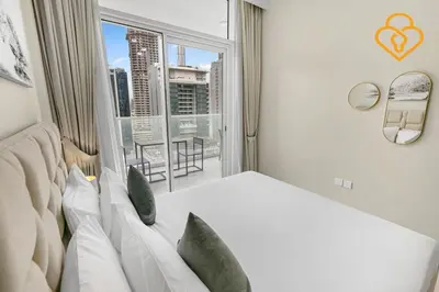 a bedroom with a white bed and a large window at Keysplease 1 BR Apt, Vera Residence Business Bay in Dubai