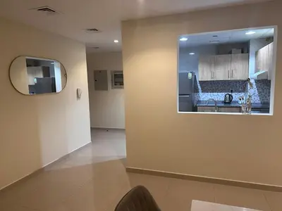 a kitchen with a sink and a mirror on a wall at Spacious 1BR Apartment with Balcony in JVC - JLiving in Dubai