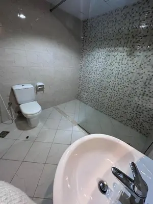 a bathroom with a sink and a toilet at Spacious 1BR Apartment with Balcony in JVC - JLiving in Dubai