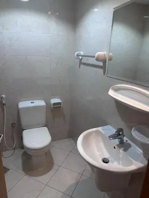 a bathroom with a toilet and a sink at Spacious 1BR Apartment with Balcony in JVC - JLiving in Dubai