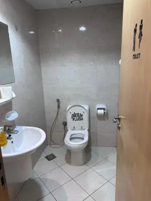 a bathroom with a toilet and a sink at Large 1BR Apartment with Balcony in JVC - JLiving in Dubai