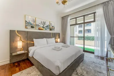 a bedroom with a large bed and a large window at Souk Al Bahar Luxury stays near poolside with Burj Khalifa view by Norbu Holiday Homes in Dubai