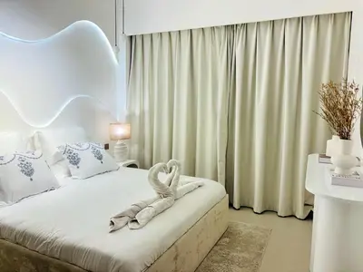 a bedroom with a bed with a towel on it at Luxury 1BR Apt Best view Infinity Pool Burj Khalifa with Balcony in Dubai