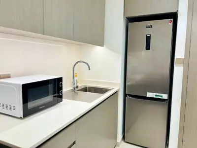 a kitchen with a microwave and a sink at Luxury 1BR Apt Best view Infinity Pool Burj Khalifa with Balcony in Dubai