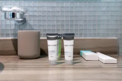 two bottles ofodorizers sitting on a counter in a bathroom at Damac Paramount Tower Burj Views in Dubai