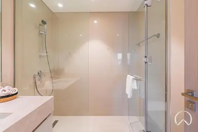 a bathroom with a shower with a glass door at Luxurious 4BR In Act 1 Act 2 With Burj Khalifa View in Dubai