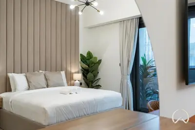 a bedroom with a white bed and a window at Luxurious 4BR In Act 1 Act 2 With Burj Khalifa View in Dubai