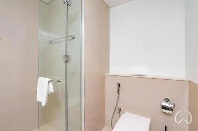 a bathroom with a shower with a glass door at Luxurious 4BR In Act 1 Act 2 With Burj Khalifa View in Dubai