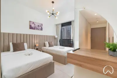 a hotel room with two beds and a mirror at Luxurious 4BR In Act 1 Act 2 With Burj Khalifa View in Dubai