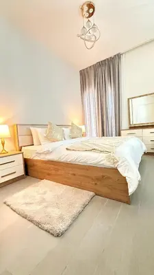 a bedroom with a bed and a window and a rug at Brand New Golf View - Luxe Nest at Dubai Hills one bedroom apartment in Dubai