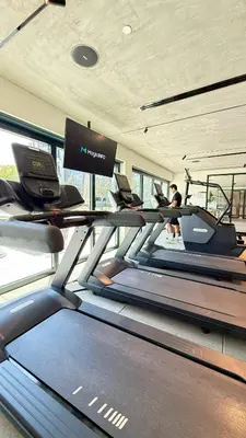 a gym with tread machines and a treadmill at Brand New Golf View - Luxe Nest at Dubai Hills one bedroom apartment in Dubai