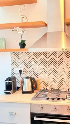 a kitchen with a stove and a microwave at Brand New Golf View - Luxe Nest at Dubai Hills one bedroom apartment in Dubai