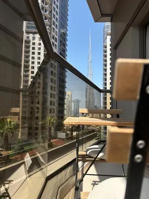 a table and chairs on a balcony with a view of a city at Burj Khalifa View from your Balcony in Dubai