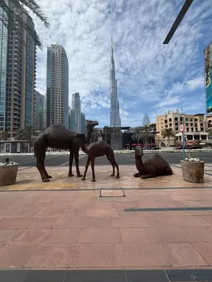 a statue of horses and seals on a city street at Burj Khalifa View from your Balcony in Dubai