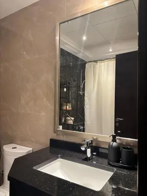 a bathroom with a sink and a mirror and a toilet at Burj Khalifa View from your Balcony in Dubai