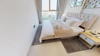 a bedroom with a large white bed and a window at Tranquil Oasis 2BR at Collective Dubai Hills in Dubai