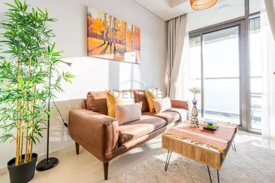 a living room with a brown couch and a table at Close to Dubai Water Canal 1BR with Balcony, Aykon City 2 Tower C, Business Bay by Deluxe Holiday Homes in Dubai