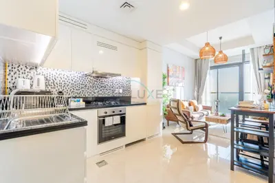 a kitchen with white appliances and a living room at Close to Dubai Water Canal 1BR with Balcony, Aykon City 2 Tower C, Business Bay by Deluxe Holiday Homes in Dubai