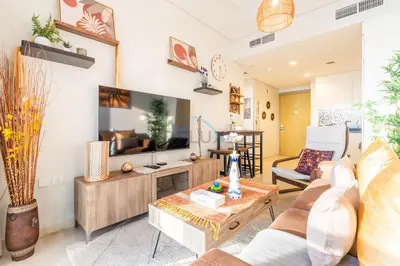 a living room with a couch and a tv at Close to Dubai Water Canal 1BR with Balcony, Aykon City 2 Tower C, Business Bay by Deluxe Holiday Homes in Dubai