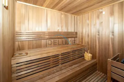 a wooden sauna with a bench in a room at Close to Dubai Water Canal 1BR with Balcony, Aykon City 2 Tower C, Business Bay by Deluxe Holiday Homes in Dubai