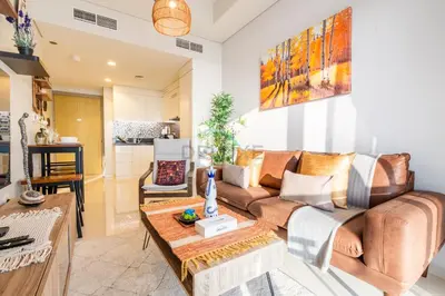 a living room with a couch and a table at Close to Dubai Water Canal 1BR with Balcony, Aykon City 2 Tower C, Business Bay by Deluxe Holiday Homes in Dubai