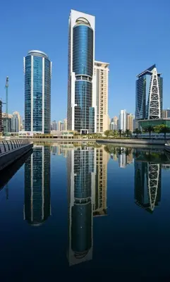 a city skyline with tall buildings and a body of water at ZenStay - Cozy Studio with City Views in Dubai
