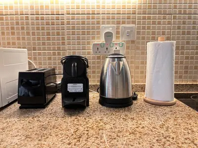 a kitchen counter with a coffee maker and a toaster at ZenStay - Cozy Studio with City Views in Dubai