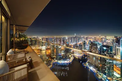a view of a city at night from a balcony at Marina Gate Luxury Full Marina & Sunset Sea Views in Dubai