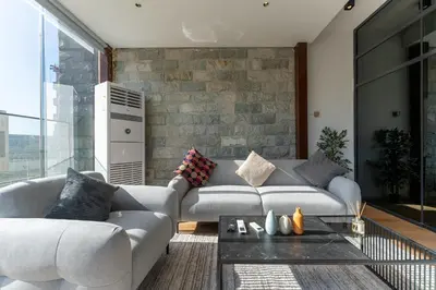 a living room with a couch and a table at HAVN - Modern Studio in JVC with Huge Layout in Dubai